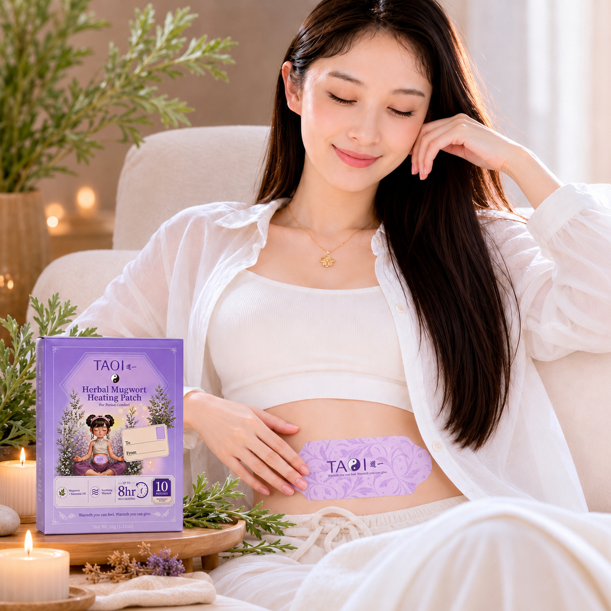 A woman sitting on a couch with a TAOI herbal Mugwort heating patch on her abdomen, holding the product packaging.
